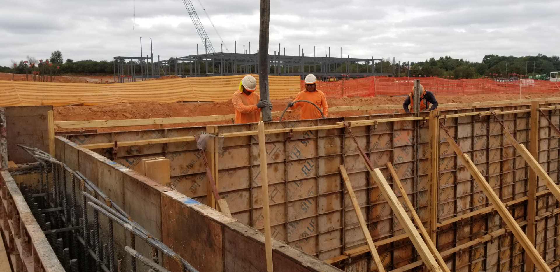 JAM crew placing concrete in commercial wall forms
